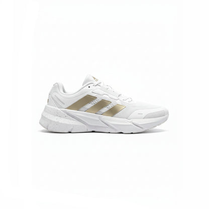 White sneaker with gold stripes on a white background