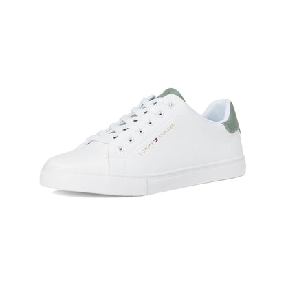 White sneaker with green accents on a white background